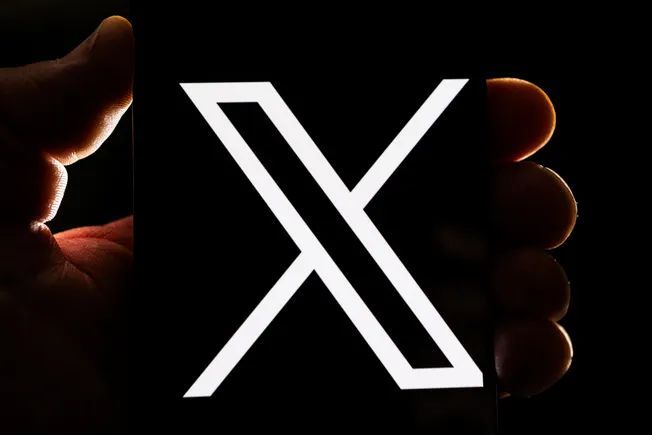 X combats AI-generated content while promoting Grok